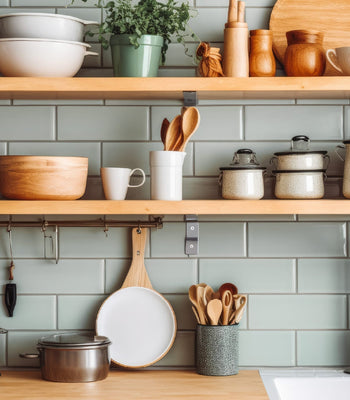 Open kitchen shelving with neatly arranged cookware and dishes, creating a functional and visually calm cooking space