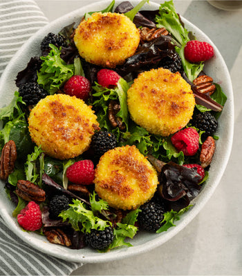 Crispy goat cheese salad with berries, maple pecans, and mixed greens
