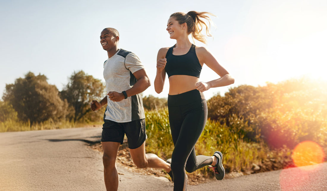 Two people running side by side outdoors, symbolizing fitness, energy balance, and healthy habits for muscle gain and fat loss