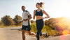 Two people running side by side outdoors, symbolizing fitness, energy balance, and healthy habits for muscle gain and fat loss