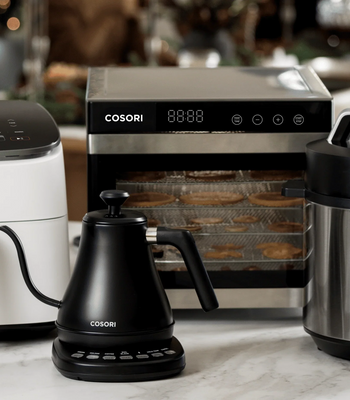 Cosori holiday gift guide collection featuring a white air fryer, pressure cooker, kettle, and dehydrator