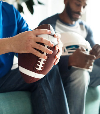 Friends watching a football game together during a game day party