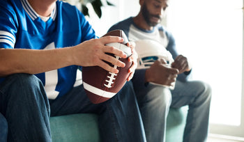Friends watching a football game together during a game day party