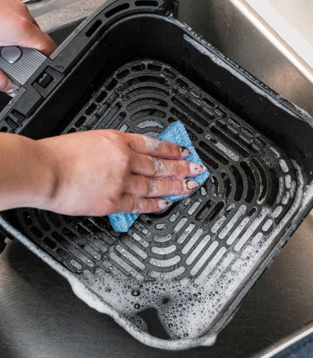 Cosori air fryer on kitchen counter showing cleaning and maintenance setup