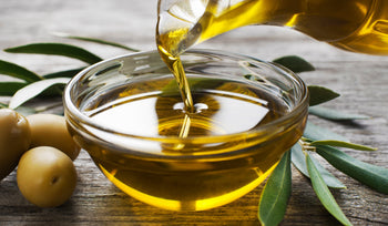 Olive oil being poured into a bowl, representing healthy cooking oils for everyday meals