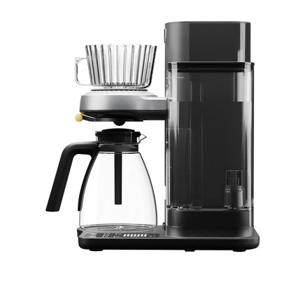 Front view of Juni automatic pour-over coffee maker with glass carafe and handle