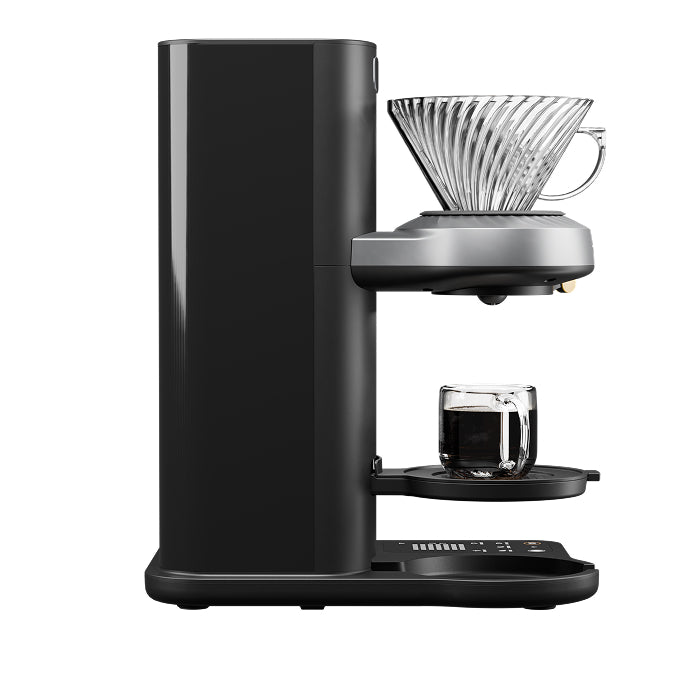 Juni automatic pour-over coffee maker brewing directly into a cup, no carafe