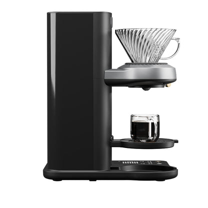 Juni automatic pour-over coffee maker brewing directly into a cup, no carafe