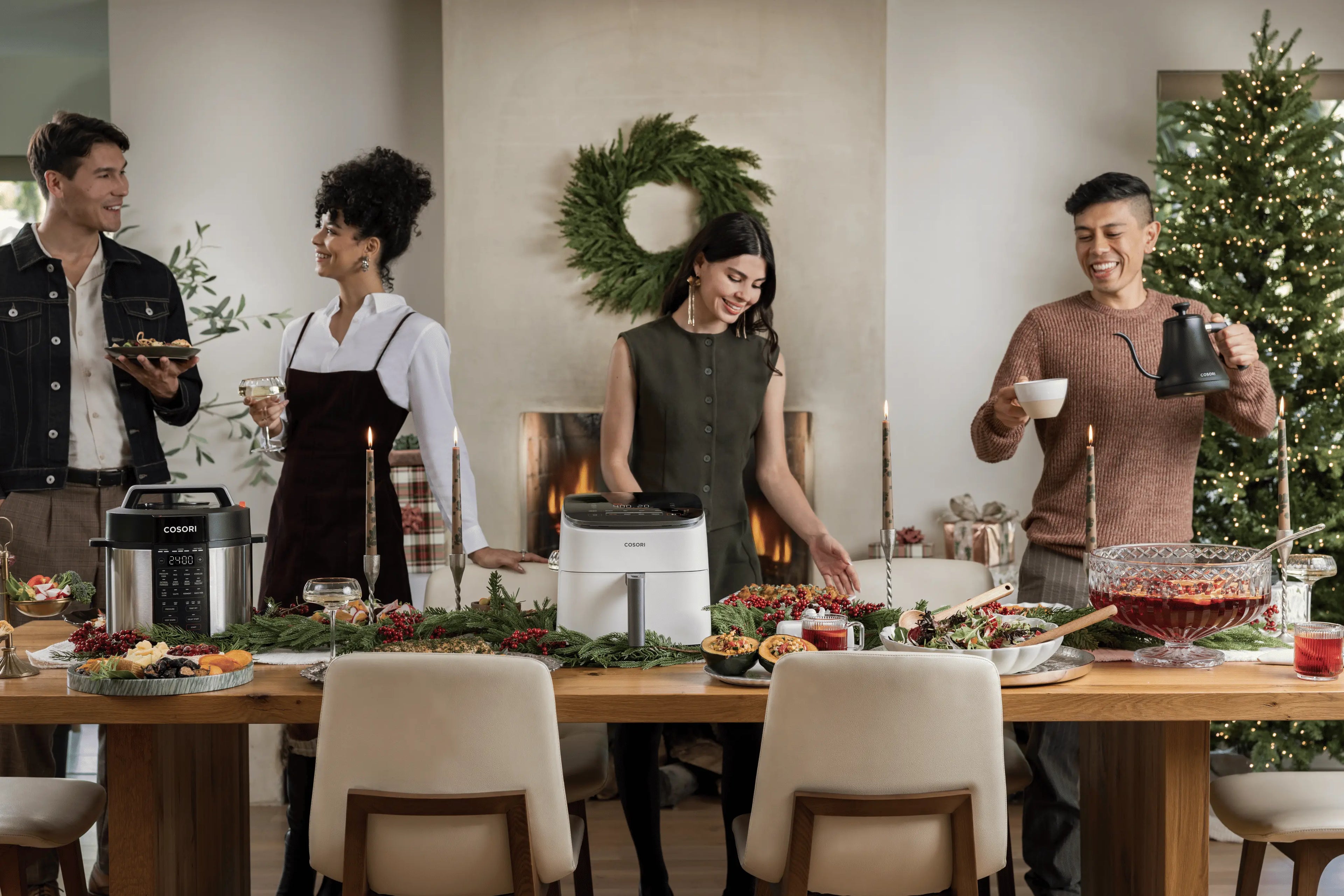 Friends gathering around a holiday table with food, drinks, and Cosori kitchen appliances.