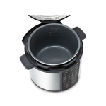 Top-down view into the open 6-quart pressure cooker pot, showing the nonstick interior coating