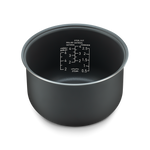 Angled view of the inner pot showing clear water measurement markings for different grain types.