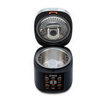 Top-down view into the open Cosori Rice Cooker showing the inner heating plate and lid structure.