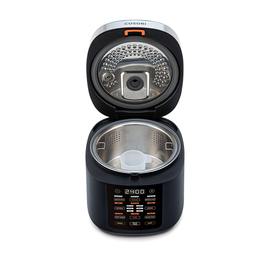 Top-down view into the open Cosori Rice Cooker showing the inner heating plate and lid structure.