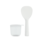 Standing rice paddle and measuring cup accessories included with the Cosori Rice Cooker