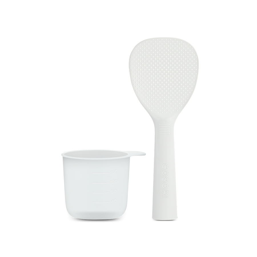 Standing rice paddle and measuring cup accessories included with the Cosori Rice Cooker