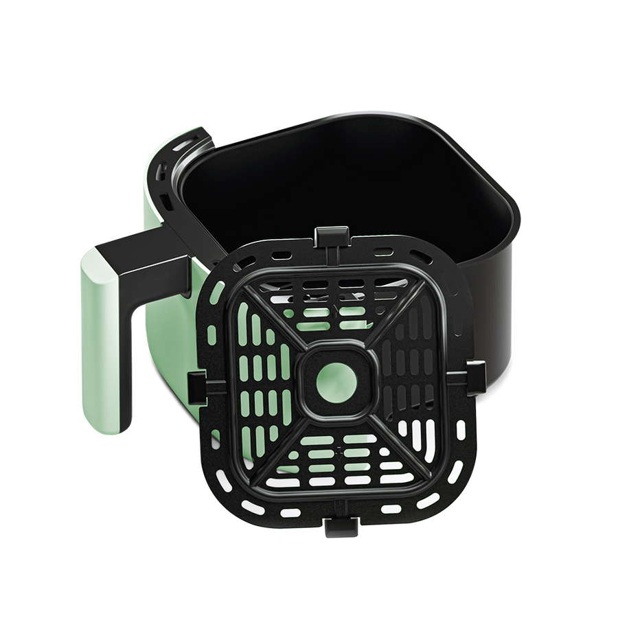 Sage green air fryer basket tilted to show the removable crisper plate inside