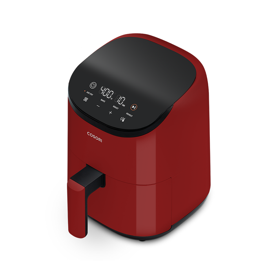 Angled front view of the red Cosori Lite 2.1-Quart Mini Air Fryer showing its matte finish