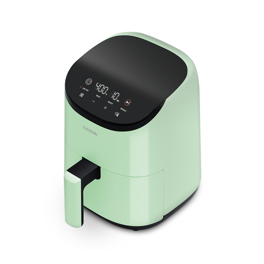 Angled view of the sage green Cosori Lite 2.1-Quart Mini Air Fryer.