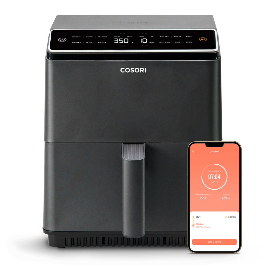COSORI Dual Blaze 6.8-Quart Smart Air Fryer with smartphone app control displayed beside the unit