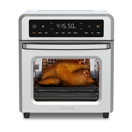 Cosori 13-Quart Air Fryer Oven with a whole roasted chicken cooking inside. Stainless steel finish