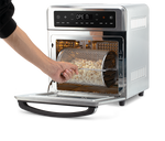 Removing the rotating mesh fry basket using the handle tool from the open Cosori Air Fryer Oven