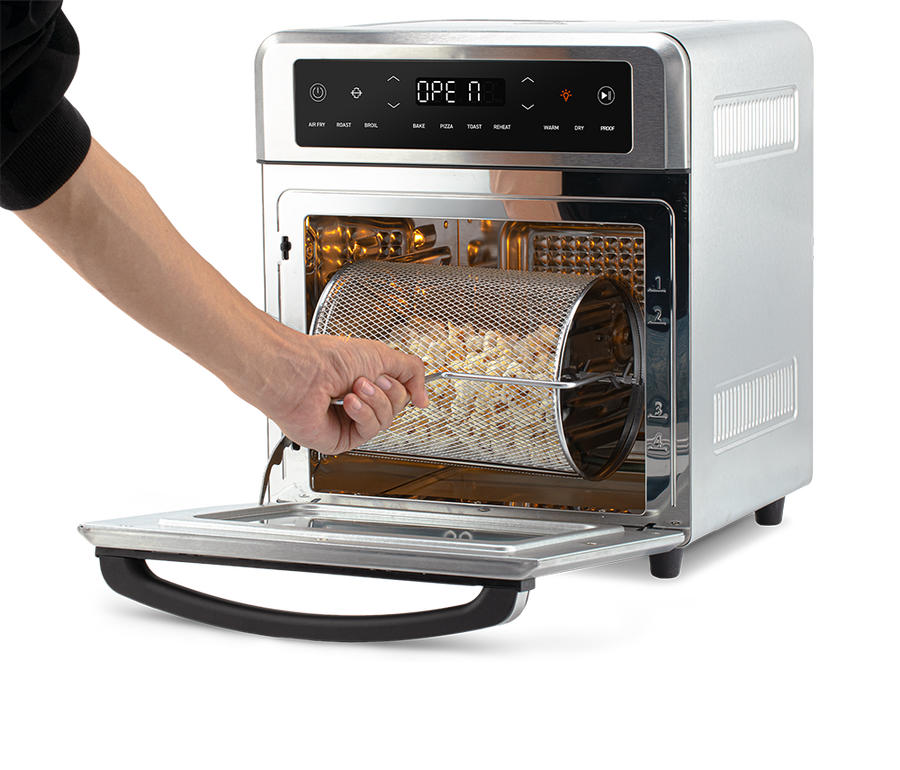Removing the rotating mesh fry basket using the handle tool from the open Cosori Air Fryer Oven