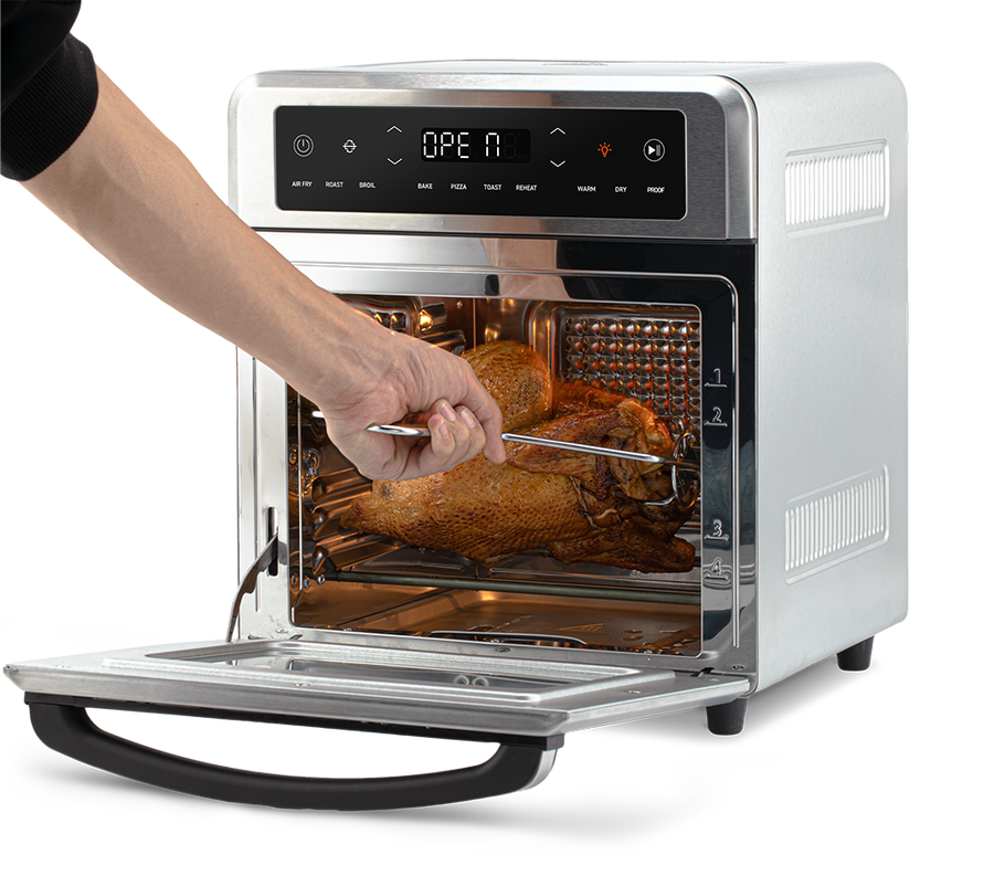 Using the fetch tool to safely remove the rotisserie spit with chicken from the Cosori Air Fryer Oven